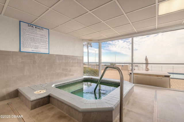 view of swimming pool featuring an indoor hot tub