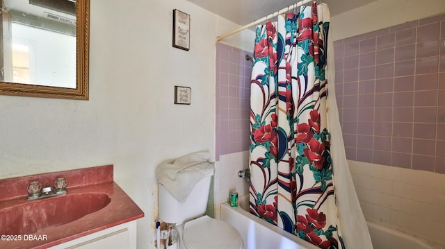 full bathroom with vanity, shower / bath combination with curtain, and toilet