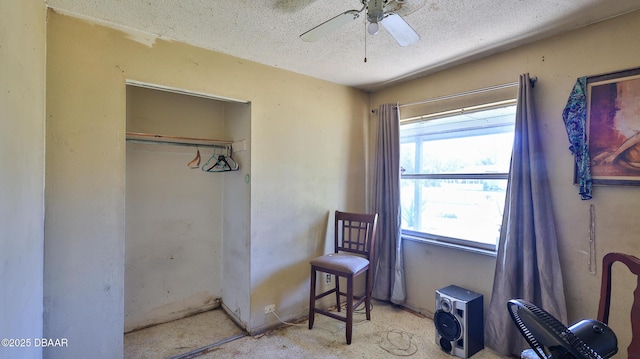 bedroom featuring multiple windows, a textured ceiling, a closet, and ceiling fan