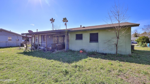 rear view of house featuring a lawn