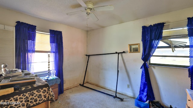 bedroom with a textured ceiling and ceiling fan