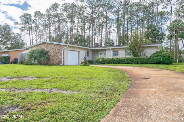 single story home featuring a garage and a front yard