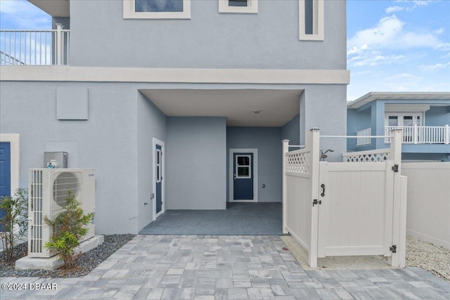 view of exterior entry with ac unit