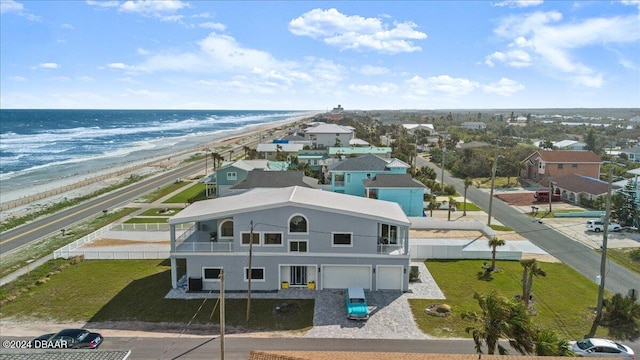 drone / aerial view featuring a beach view and a water view