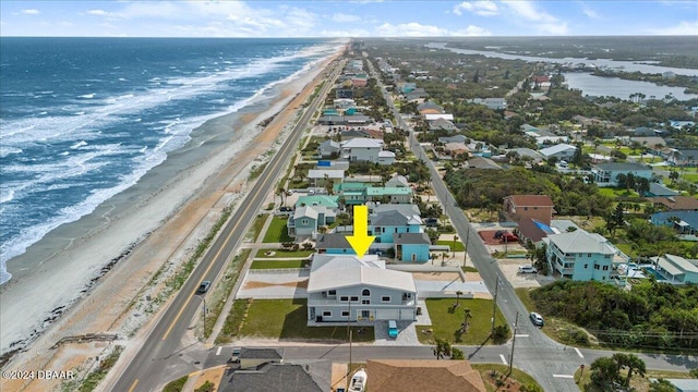 drone / aerial view with a water view and a beach view