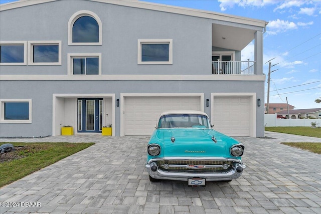 view of front of home with a balcony and a garage