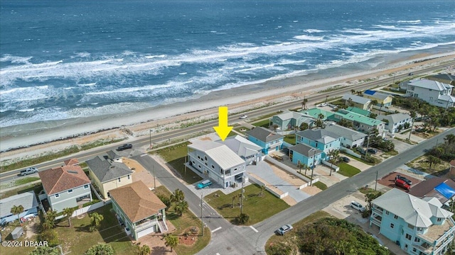 bird's eye view featuring a view of the beach and a water view