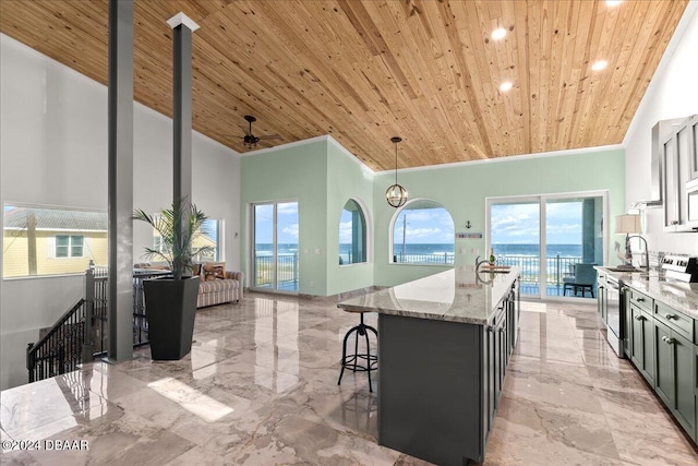 kitchen featuring a kitchen island with sink, light stone counters, pendant lighting, and wooden ceiling