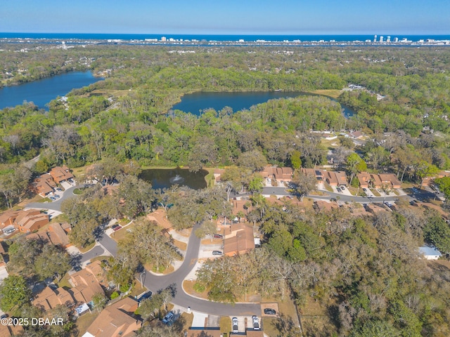 aerial view featuring a view of trees and a water view