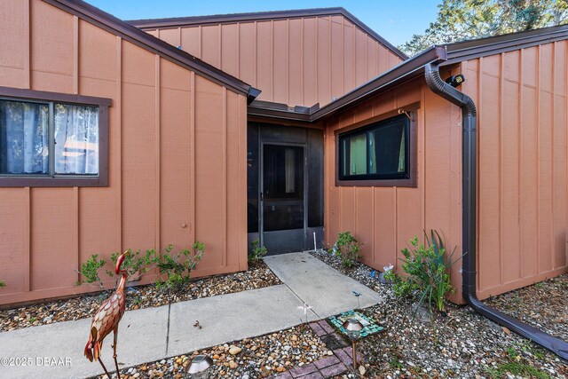 view of exterior entry with board and batten siding