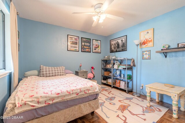 bedroom featuring a ceiling fan and baseboards