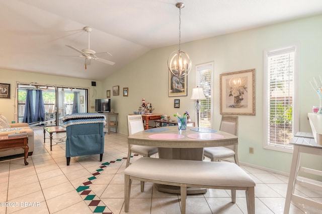 dining room with light tile patterned flooring, ceiling fan with notable chandelier, baseboards, and vaulted ceiling