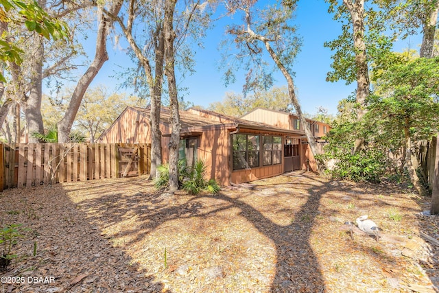 rear view of property with a fenced backyard