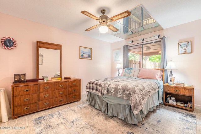 tiled bedroom with a ceiling fan