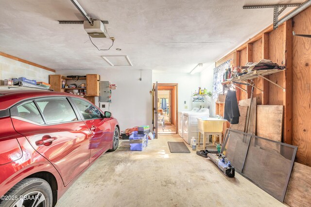 garage with a garage door opener and washer and clothes dryer