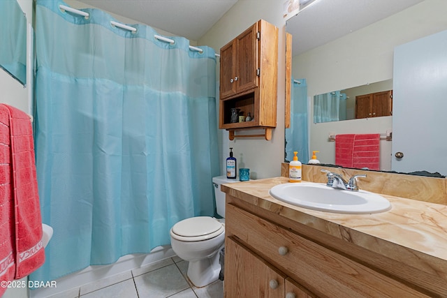 bathroom featuring tile patterned floors, shower / bath combo with shower curtain, toilet, and vanity