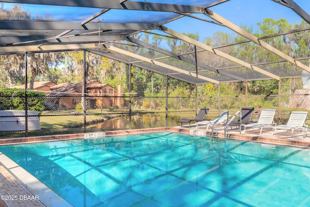 view of pool with a lanai, a patio area, a fenced in pool, and fence