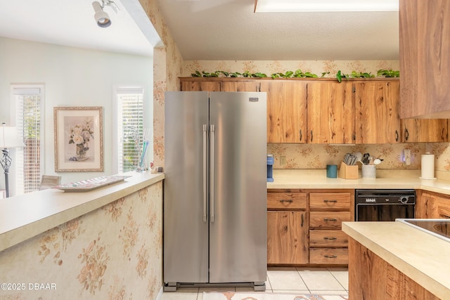 kitchen featuring dishwasher, light countertops, brown cabinets, light tile patterned flooring, and high end fridge