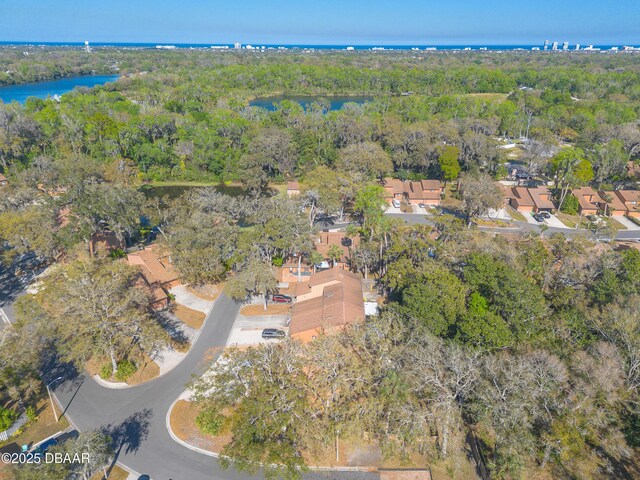 aerial view featuring a view of trees and a water view