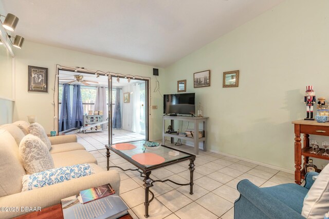 living area featuring baseboards, light tile patterned flooring, and vaulted ceiling