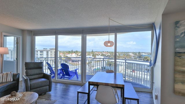 sunroom / solarium with a water view and a healthy amount of sunlight