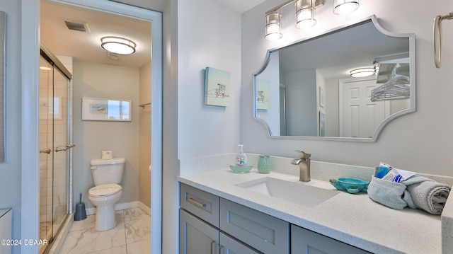 bathroom featuring vanity, toilet, and walk in shower