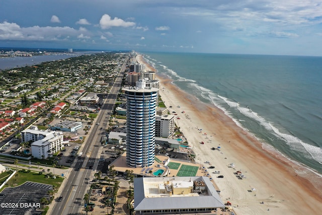 bird's eye view featuring a water view and a beach view