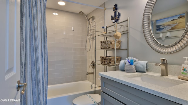 full bathroom with shower / tub combo with curtain, vanity, and toilet