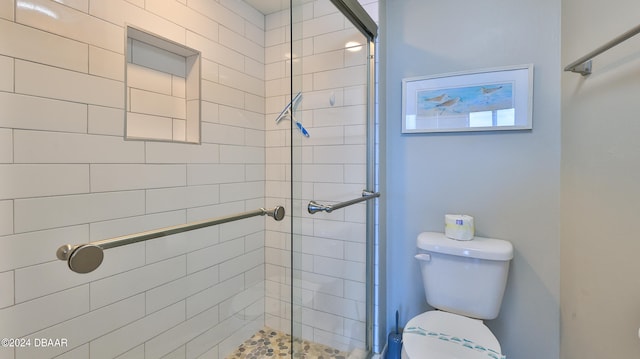 bathroom featuring toilet and an enclosed shower