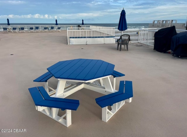 view of patio / terrace with a water view and a grill