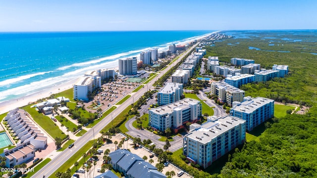 drone / aerial view with a beach view and a water view