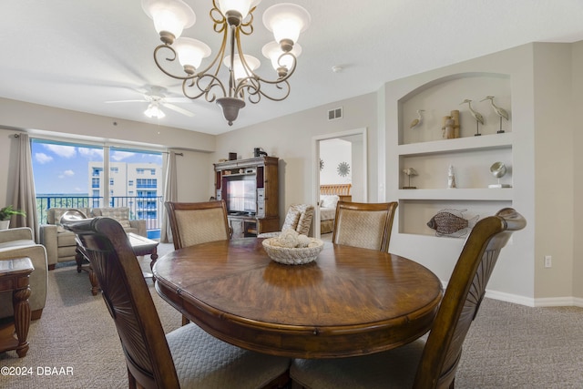 dining area featuring ceiling fan with notable chandelier, built in features, and carpet