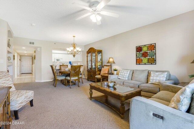 5300 S Atlantic Ave Unit 15-403, New Smyrna Beach, FL 32169 - living room featuring a ceiling fan, a chandelier, light colored carpet, and baseboards