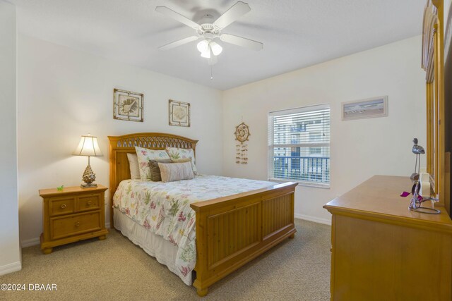 5300 S Atlantic Ave Unit 15-403, New Smyrna Beach, FL 32169 - bedroom featuring light colored carpet, baseboards, and ceiling fan