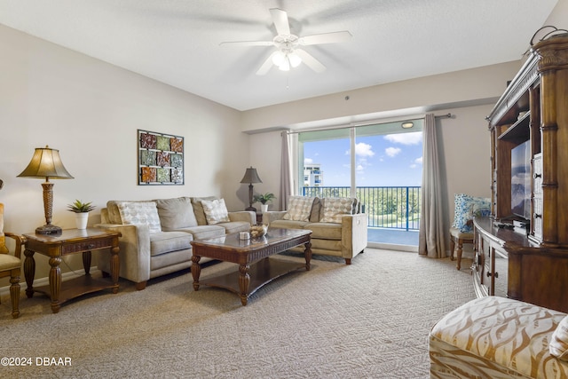 carpeted living room with a textured ceiling and ceiling fan