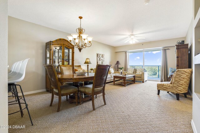 5300 S Atlantic Ave Unit 15-403, New Smyrna Beach, FL 32169 - carpeted dining space with ceiling fan, a chandelier, and baseboards