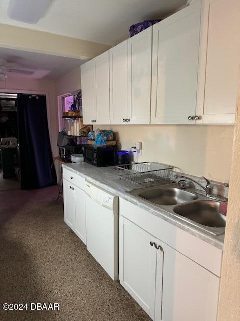 kitchen featuring white cabinetry, sink, and white dishwasher