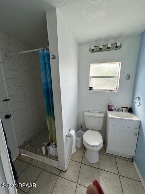 bathroom featuring a shower with curtain, tile patterned flooring, toilet, and vanity