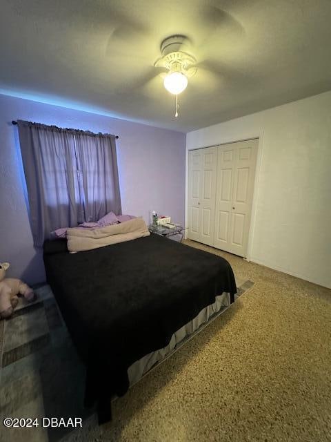 bedroom with ceiling fan and a closet