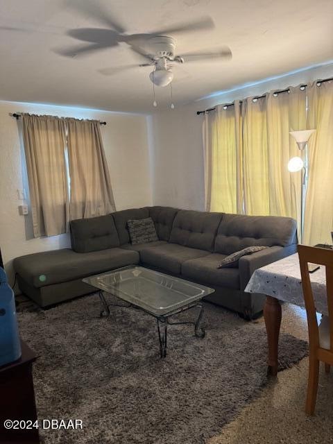 living room with carpet flooring and ceiling fan