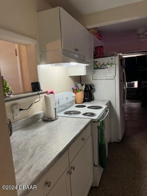 kitchen featuring white cabinetry and white electric range oven