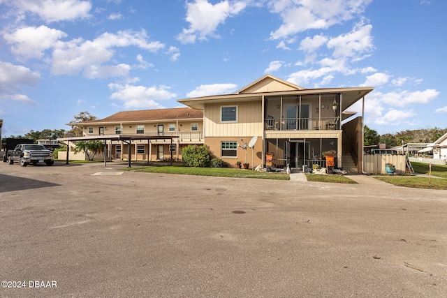 view of front of home featuring a balcony and a carport