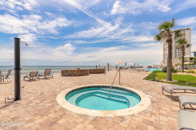 2515 S Atlantic Ave Unit 703, Daytona Beach, FL 32118 - view of pool with a community hot tub, a water view, and a patio