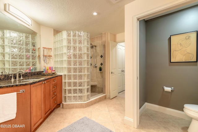 2515 S Atlantic Ave Unit 703, Daytona Beach, FL 32118 - bathroom featuring a shower stall, vanity, tile patterned floors, and a textured ceiling