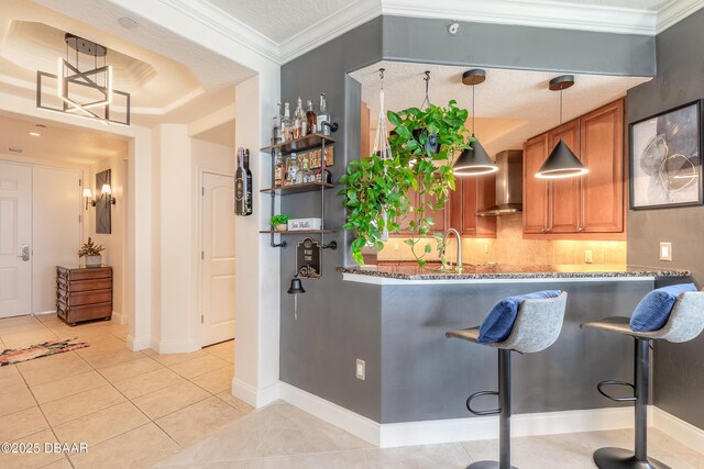 2515 S Atlantic Ave Unit 703, Daytona Beach, FL 32118 - bar with wall chimney exhaust hood, light tile patterned floors, tasteful backsplash, hanging light fixtures, and ornamental molding