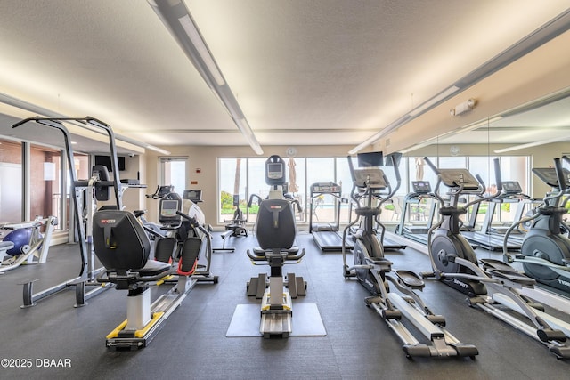 2515 S Atlantic Ave Unit 703, Daytona Beach, FL 32118 - exercise room featuring a textured ceiling and healthy amount of natural light