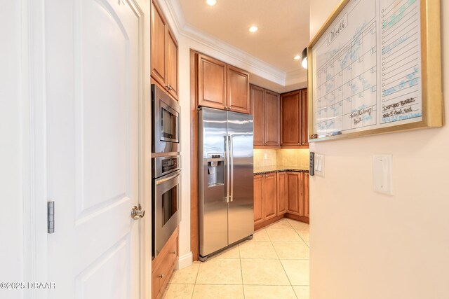 2515 S Atlantic Ave Unit 703, Daytona Beach, FL 32118 - kitchen with stainless steel appliances, ornamental molding, recessed lighting, backsplash, and light tile patterned floors