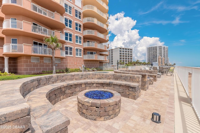 2515 S Atlantic Ave Unit 703, Daytona Beach, FL 32118 - view of patio featuring a fire pit