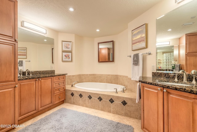 2515 S Atlantic Ave Unit 703, Daytona Beach, FL 32118 - full bathroom with tile patterned floors, two vanities, a bath, recessed lighting, and a textured ceiling