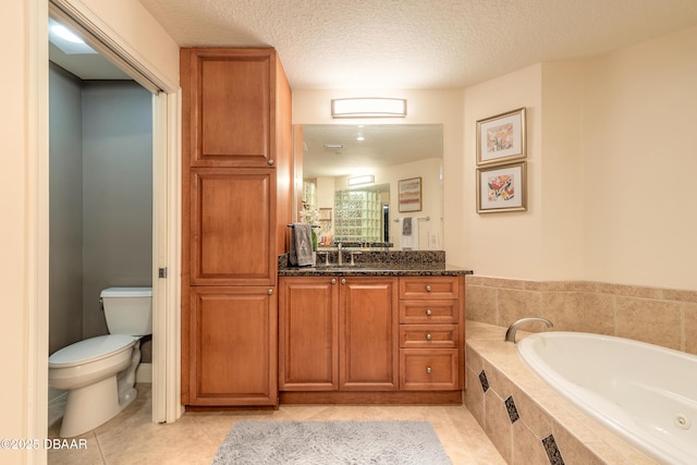 2515 S Atlantic Ave Unit 703, Daytona Beach, FL 32118 - bathroom with a garden tub, vanity, tile patterned flooring, and a textured ceiling